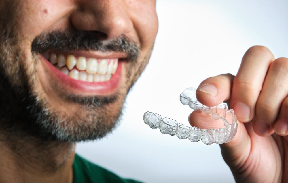Man holding his Invisalign