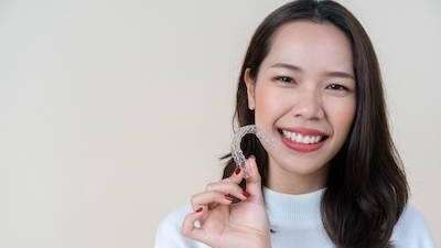 Woman holding Invisalign